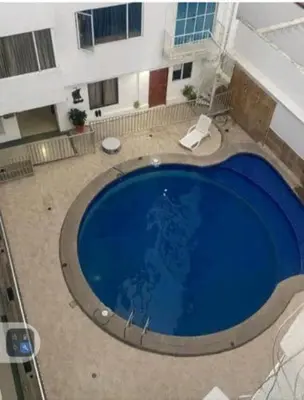 a large blue swimming pool in the middle of a building at Apartaestudio Económico en Cartagena, al lado de la Playa in Cartagena de Indias
