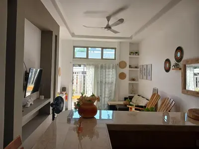 a living room with a table and a tv at Mararena in Coveñas