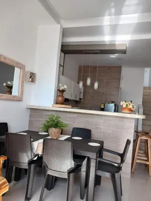 a kitchen and dining room with a table and chairs at Mararena in Coveñas