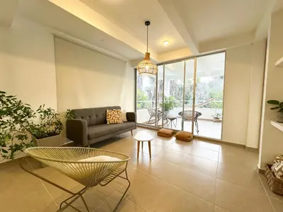 a living room with a couch and a table at Villa in Sabanilla near the Sea in Maizal