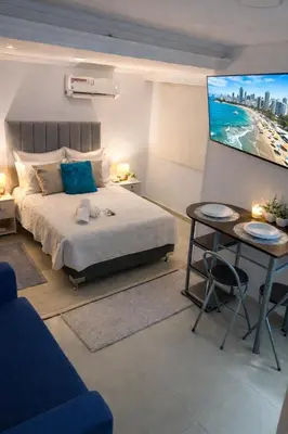 a bedroom with a bed and a flat screen tv at Apartaestudio Económico a una cuadra de la Playa in Cartagena de Indias
