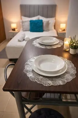 a wooden table with two plates on top of it at Apartaestudio Económico a una cuadra de la Playa in Cartagena de Indias