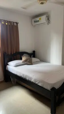 a bed in a room with avertisementatronatronstrationstrationstrationstration at GUILLO Comfort Loft 2 in Cartagena de Indias