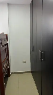 a room with two black cabinets and a white wall at GUILLO Comfort Loft 2 in Cartagena de Indias