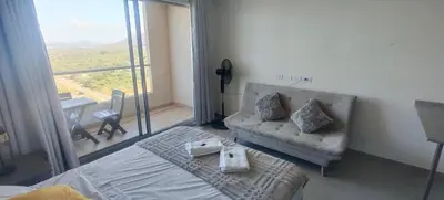 a bedroom with a bed and a couch and a table at Santa marina in Santa Marta