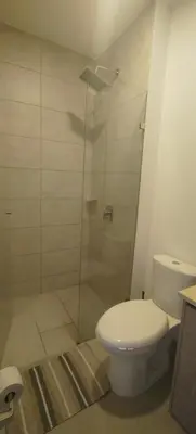 a bathroom with a toilet and a glass shower at Santa marina in Santa Marta