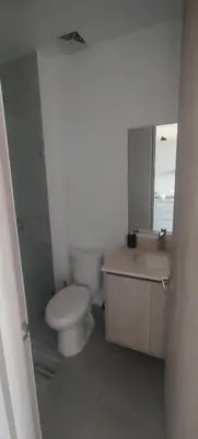 a bathroom with a toilet and a sink and a mirror at Santa marina in Santa Marta