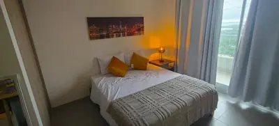 a bedroom with a bed with yellow pillows and a window at Santa marina in Santa Marta