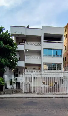 a white building with a white fence in front of it at Tourist apartment steps from the Historic Center in Cartagena de Indias