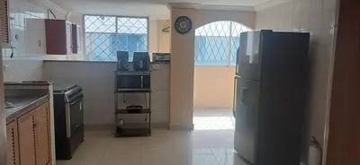 a kitchen with a refrigerator in the middle of a room at Tourist apartment steps from the Historic Center in Cartagena de Indias