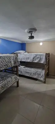 two beds in a room with two benches and a ceiling at Tourist apartment steps from the Historic Center in Cartagena de Indias