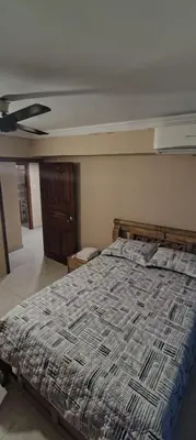 a bedroom with a bed with a comforter on it at Tourist apartment steps from the Historic Center in Cartagena de Indias