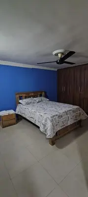 a bedroom with a bed with a ceiling fan at Tourist apartment steps from the Historic Center in Cartagena de Indias