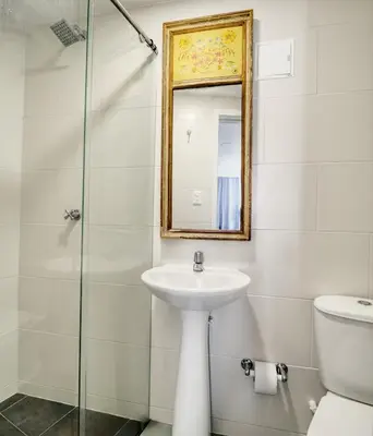 a bathroom with a sink and a mirror and a toilet at Marèlago Apartamentos in Cartagena de Indias