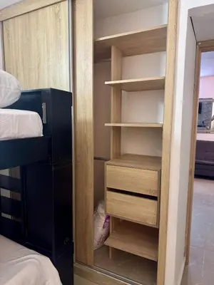 a closet with wooden shelves and a bed in a room at Apartamento moderno in Cartagena de Indias
