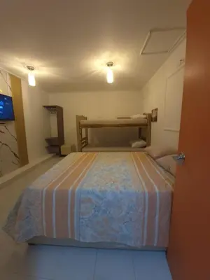 a small bedroom with a bed in a room at Hermoso apartamento loft en la ciudad amurallada de cartagena 1 in Cartagena de Indias