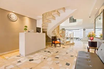 a large lobby with a staircase and a room at Beautiful House 3 minutes from Historic Downtown in Cartagena de Indias