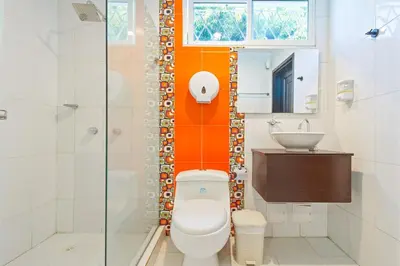 a bathroom with a toilet and a sink at Beautiful House 3 minutes from Historic Downtown in Cartagena de Indias