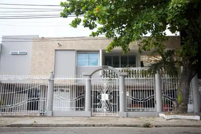 a white fence in front of a house at Beautiful House 3 minutes from Historic Downtown in Cartagena de Indias