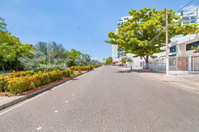 an empty street in a city with trees and flowers at Beautiful House 3 minutes from Historic Downtown in Cartagena de Indias