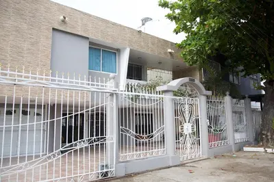 a white gate in front of a house at Beautiful House 3 minutes from Historic Downtown in Cartagena de Indias