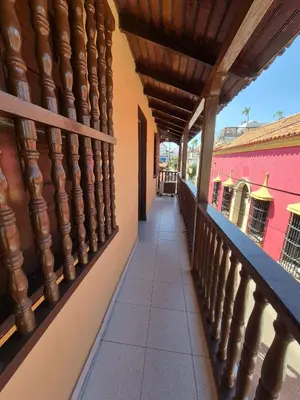 a balcony of a house with pink walls at Hermoso apartamento loft en la ciudad amurallada de cartagena 2 in Cartagena de Indias