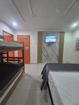 a room with two beds and a tv on a wall at Hermoso apartamento loft en la ciudad amurallada de cartagena 2 in Cartagena de Indias