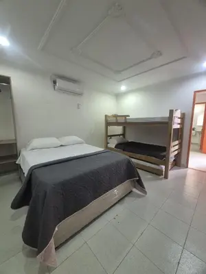 a bedroom with a bed and two bunk beds at Hermoso apartamento loft en la ciudad amurallada de cartagena 2 in Cartagena de Indias
