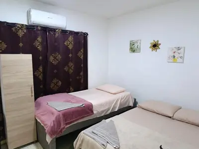 a room with two beds and a couch and a room with at Hostal Mastcoy in Cartagena de Indias