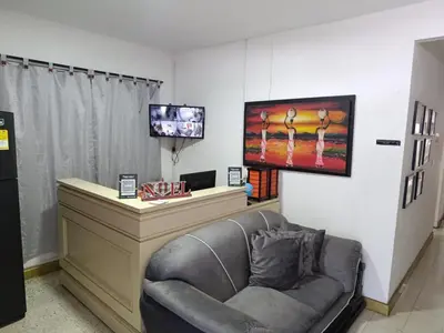 a living room with a couch and a flat screen tv at Hostal Mastcoy in Cartagena de Indias