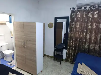 a bedroom with a bed and a toilet and a curtain at Hostal Mastcoy in Cartagena de Indias