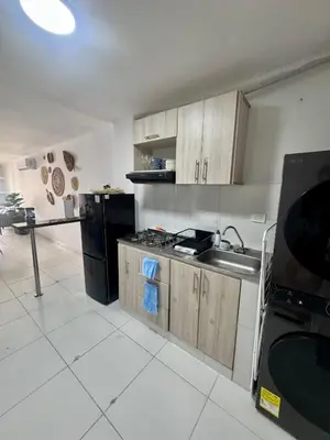 a kitchen with a sink and a black refrigerator at Cozy duplex at Cartagena City Center in Cartagena de Indias