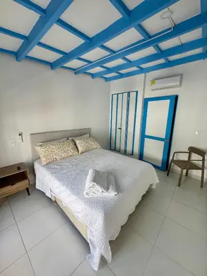 a bedroom with a bed with a blue ceiling at Cozy duplex at Cartagena City Center in Cartagena de Indias