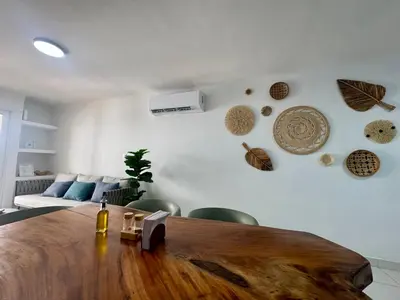 a living room with a wooden table and a couch at Cozy duplex at Cartagena City Center in Cartagena de Indias