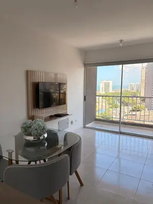 a living room with a table and a large window at Brand new apartment near the beach and historic center in Cartagena de Indias