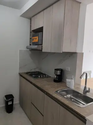 a kitchen counter with a sink and a microwave at Brand new apartment near the beach and historic center in Cartagena de Indias