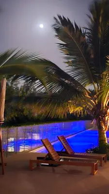 two lounge chairs on a beach with a palm tree at APARTAMENTO MORROS EOS y ECO VISTA AL MAR in Cartagena de Indias