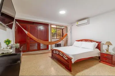 a bedroom with a bed and a hammock in it at Guest bedrooms economy in Bocagrande Beach Cartagena in Cartagena de Indias