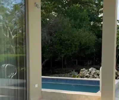 a view of a pool through a glass door at Casa Azure Playas del Francés in El Puertón