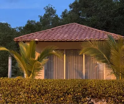 a house with a red roof and two palm trees at Casa Azure Playas del Francés in El Puertón
