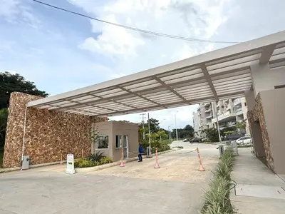 awning over a parking lot in front of a building at Nuevo Penthouse en Baia Kristal con gran terraza in Cartagena de Indias