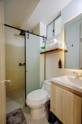 a bathroom with a toilet and a sink and a shower at Aguita de coco in Cartagena de Indias