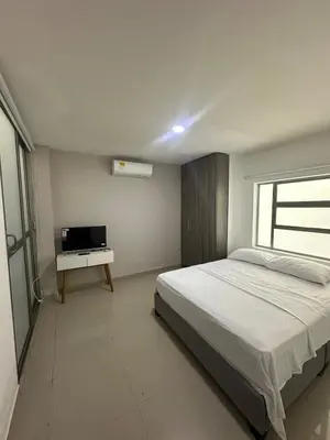 a bedroom with a bed and a television in it at Modern apartment in Boston, Sincelejo in Sincelejo