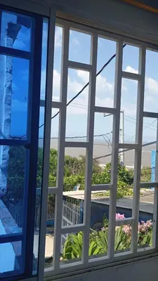 a window with a view of a garden through it at Casa vista al mar in Puerto Colombia