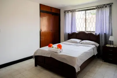 a bedroom with a bed with two flowers on it at Charming and relaxing in Manga! Close to Getsemaní in Cartagena de Indias