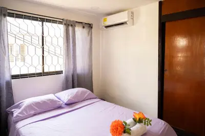 a bedroom with a bed with flowers on it at Charming and relaxing in Manga! Close to Getsemaní in Cartagena de Indias