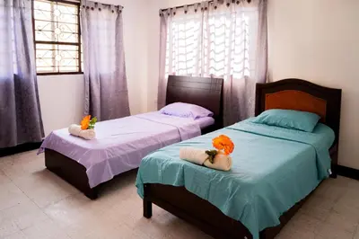 two beds in a bedroom with flowers on them at Charming and relaxing in Manga! Close to Getsemaní in Cartagena de Indias