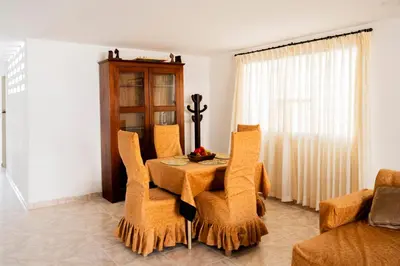 a dining room with a table and chairs and a couch at Charming and relaxing in Manga! Close to Getsemaní in Cartagena de Indias
