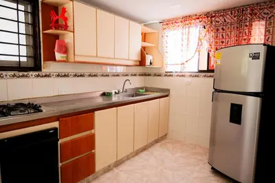 a kitchen with a sink and a refrigerator at Charming and relaxing in Manga! Close to Getsemaní in Cartagena de Indias