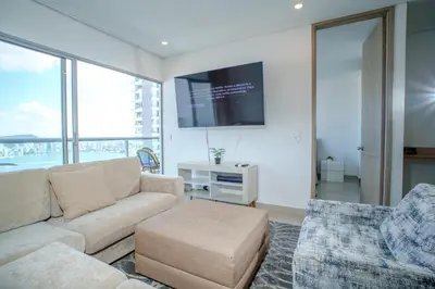 a living room with a couch and a tv at I bedroom infinitum view 32nd floor in Cartagena de Indias